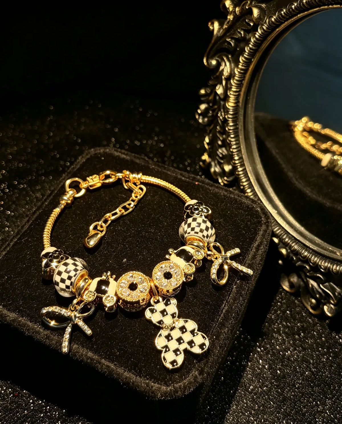 Women’s black-and-white plaid pendant bracelet with a gold-tone snake chain and beads, featuring a bow and crystal rhinestones—an elegant, luxurious jewelry gift.