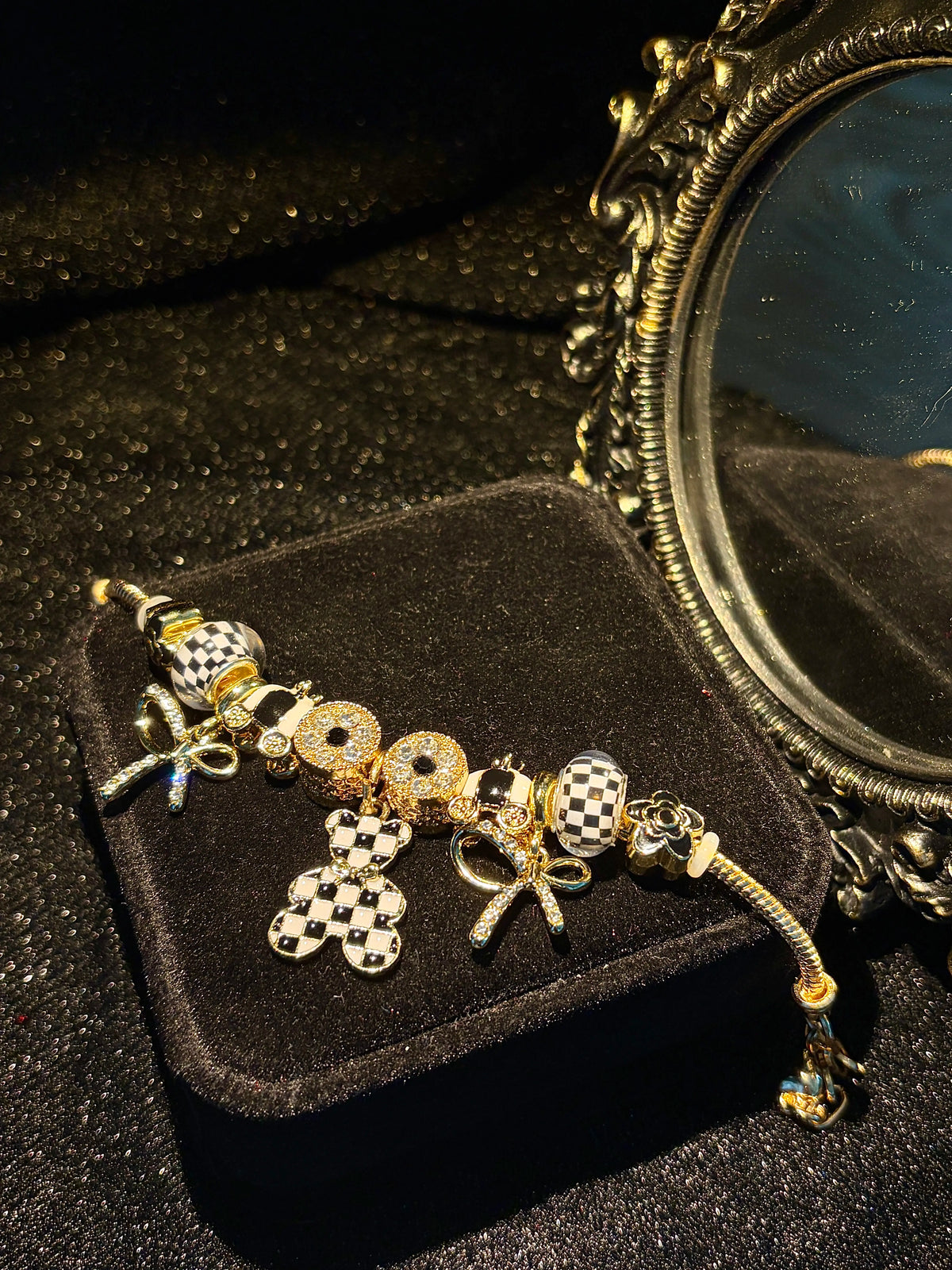 Women’s black-and-white plaid pendant bracelet with a gold-tone snake chain and beads, featuring a bow and crystal rhinestones—an elegant, luxurious jewelry gift.
