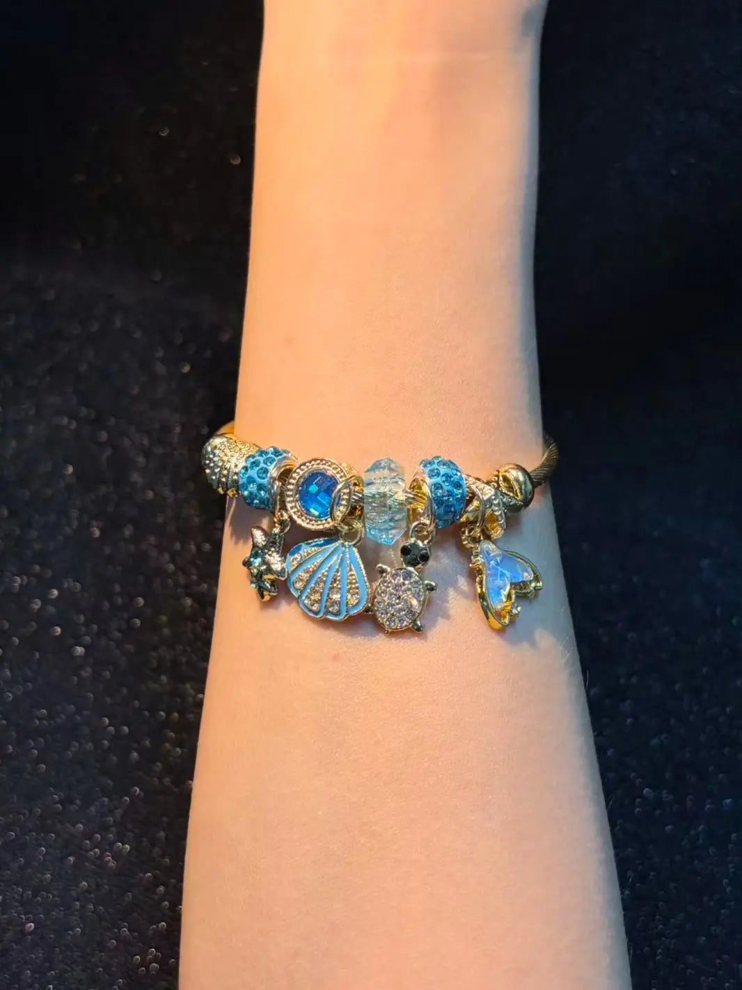Women's Gold-Tone Ocean Theme Charm Bangle - Sea Shell, Turtle, Starfish, Mermaid Tail Accents with Sparkling Blue Crystal Beads