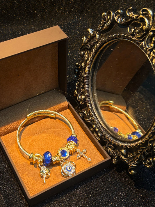 Women's Gold-Tone Open Cable Charm Bangle, Stackable Costume Jewelry Bracelet with Evil Eye, 4-Leaf Clover, Cross, Sparkling Blue Crystal Beads Charms