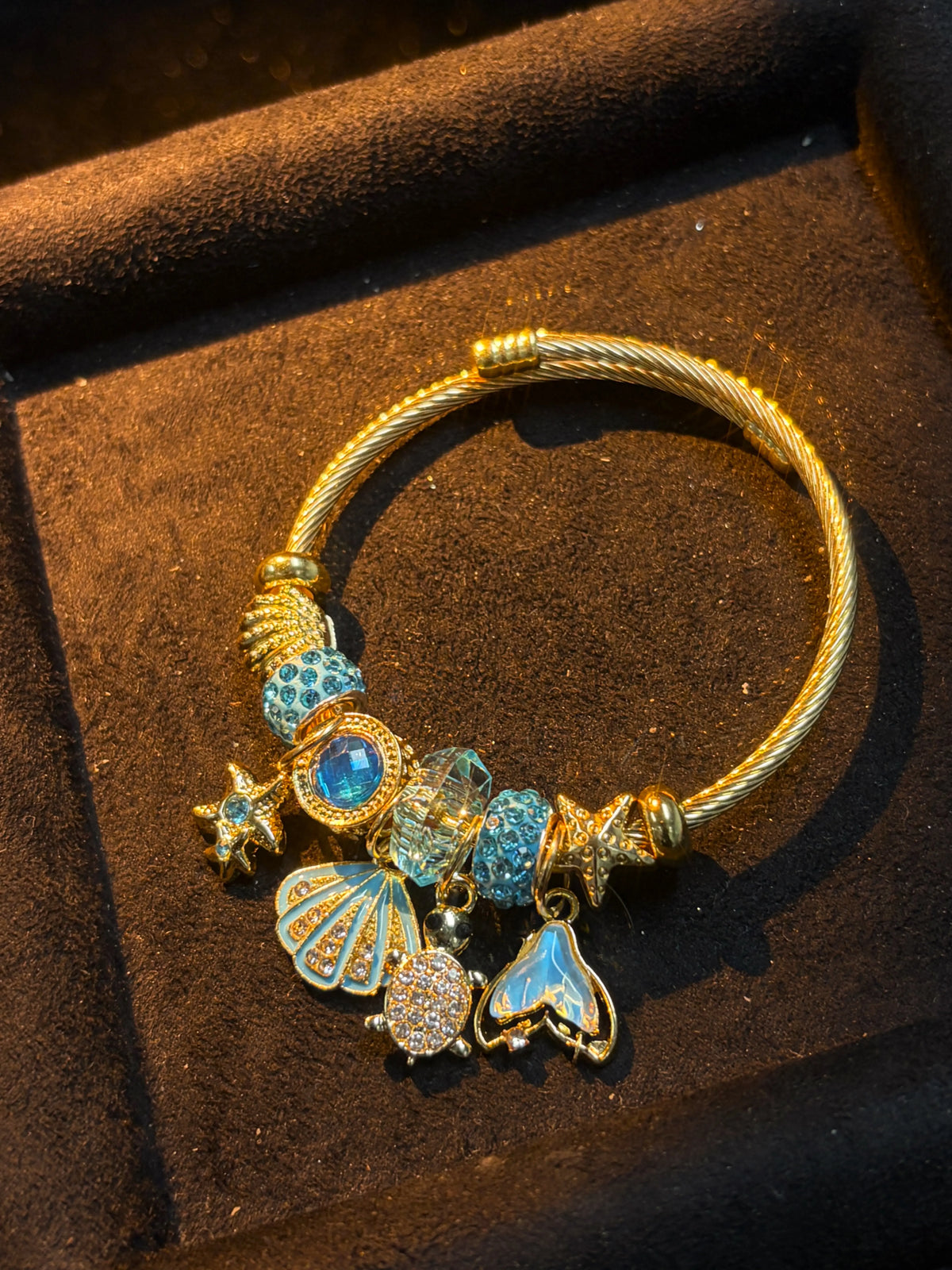 Women's Gold-Tone Ocean Theme Charm Bangle - Sea Shell, Turtle, Starfish, Mermaid Tail Accents with Sparkling Blue Crystal Beads