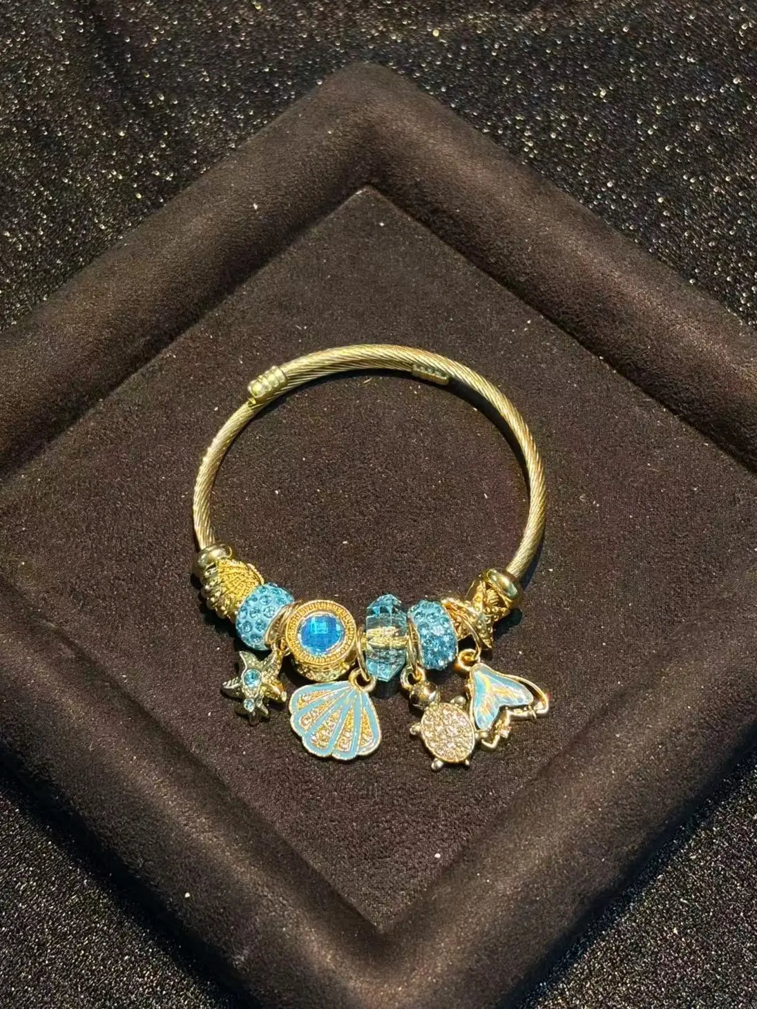 Women's Gold-Tone Ocean Theme Charm Bangle - Sea Shell, Turtle, Starfish, Mermaid Tail Accents with Sparkling Blue Crystal Beads