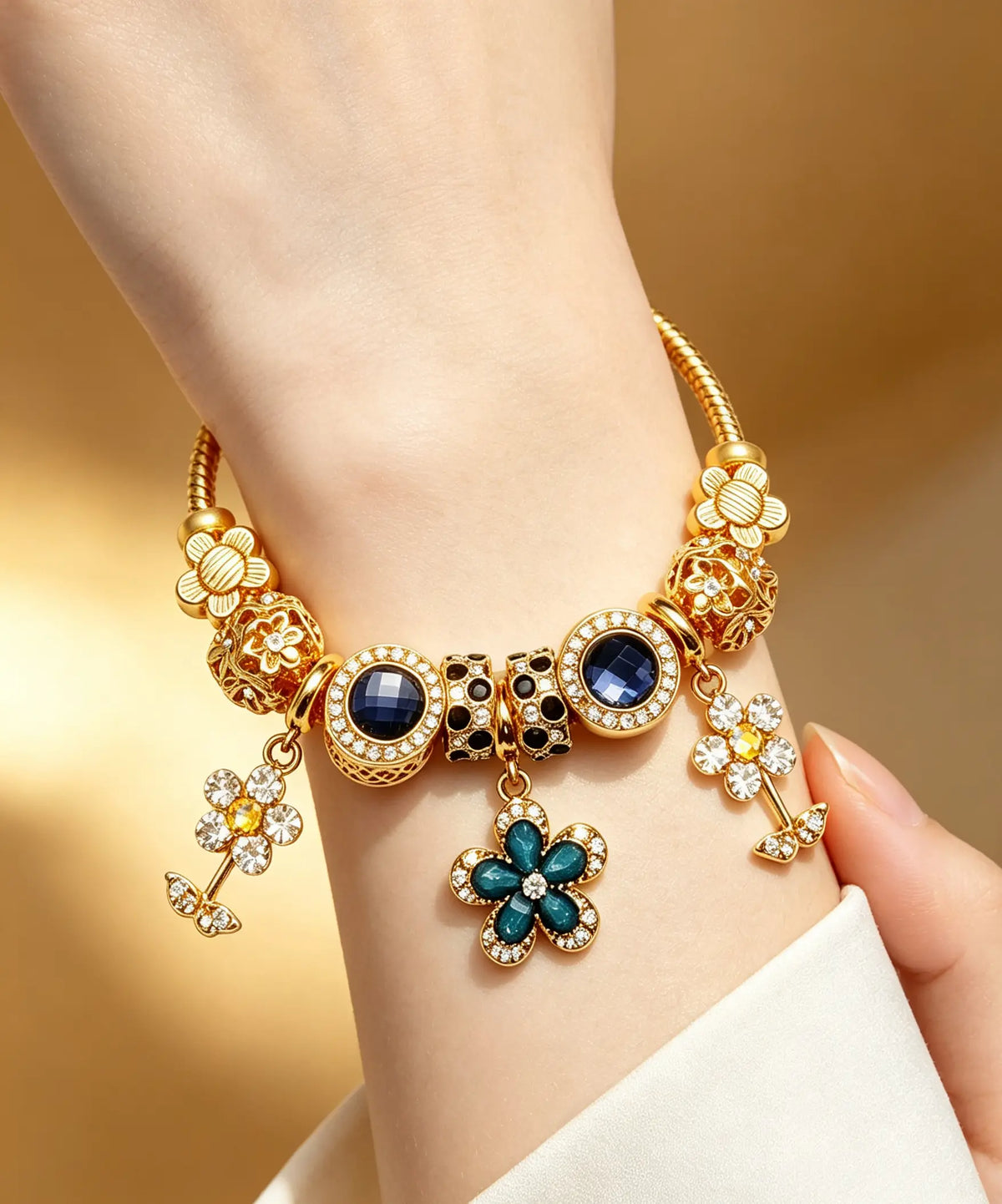 Gold-Tone Flower Charm Bracelet with Blue Crystals and Sparkling Zirconia, Fashionable Floral Pendant Design for Women's Daily Wear and Gift Giving